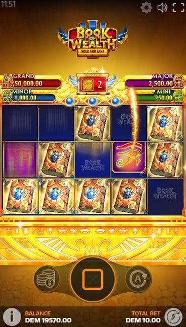 Book of Wealth III’s jackpot game in action. Bonus symbols fall on the reels, books reveal jackpots at the end of the round.