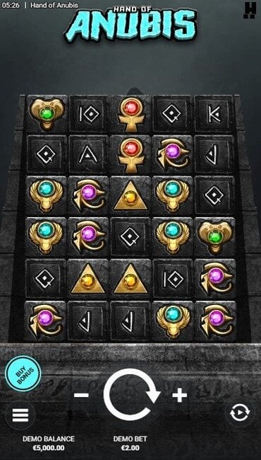 A still from Hacksaw Gaming’s Hand of Anubis, showing carved Egyptian symbols inlaid into a grey stone wall.